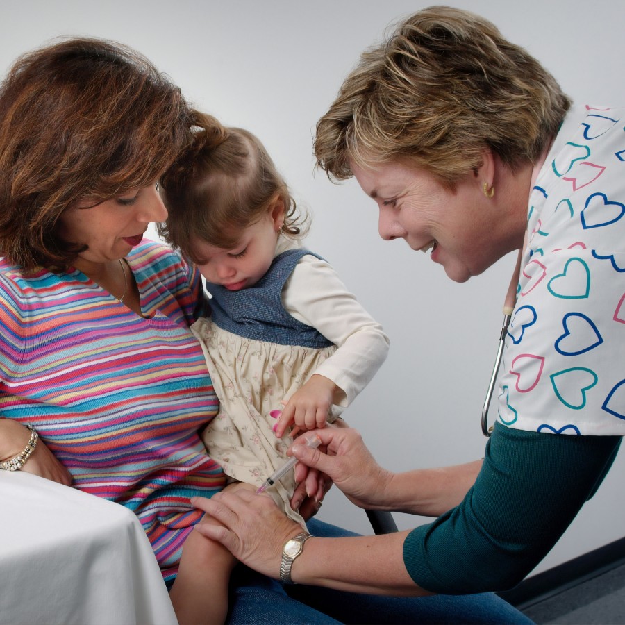 Child with a woman getting medical care